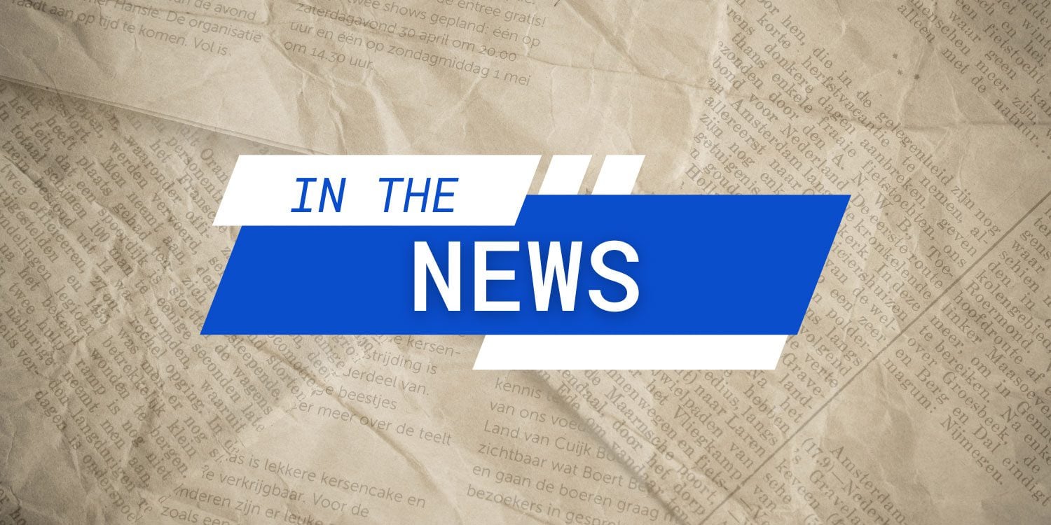 Blue and white graphic overlay with "IN THE NEWS" on newspaper.