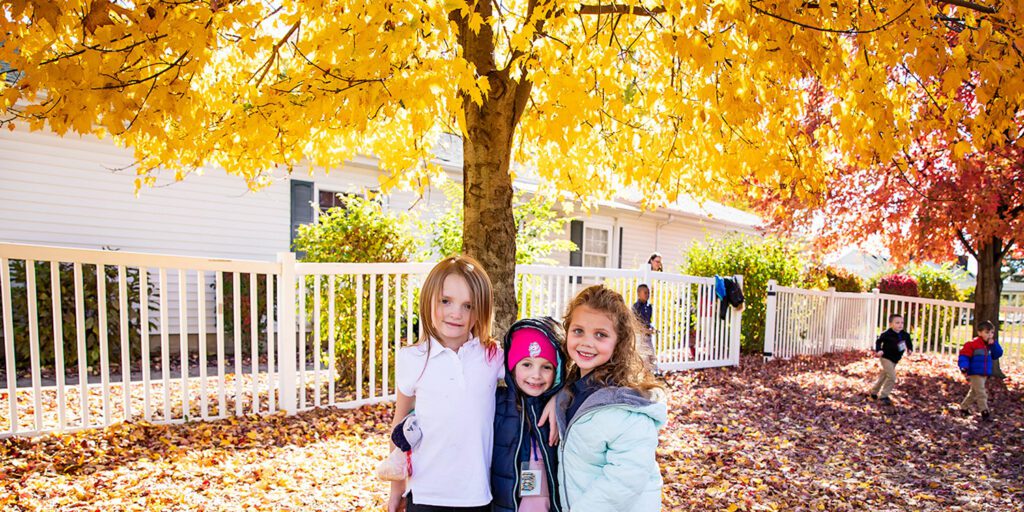 Smiling students standing together outside.